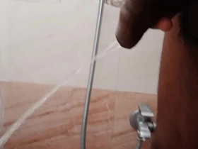 Rajesh pissing in the bathroom